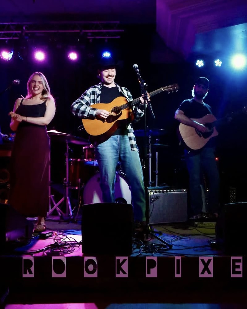 The full Josh Janes band on stage together under coloured lights